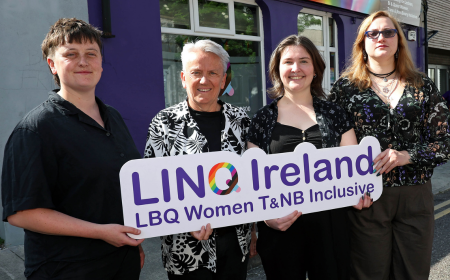 Four people holding up a sign for LINQ Ireland.
